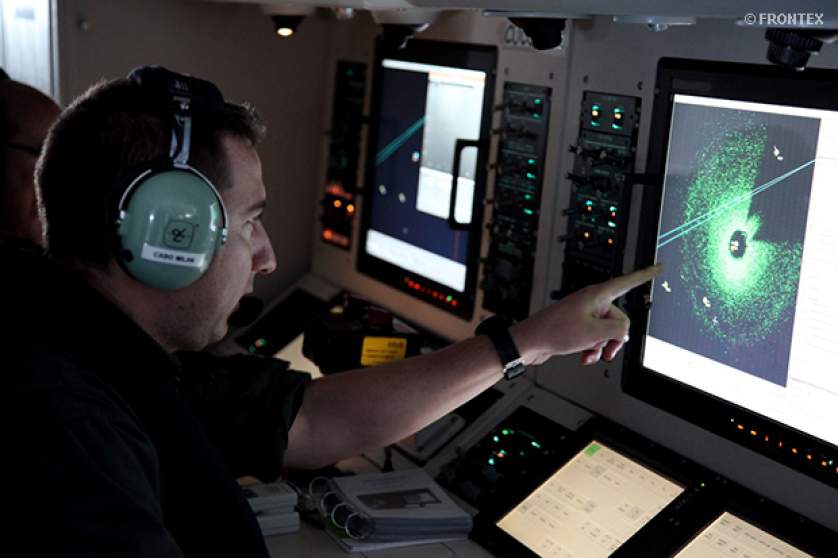 Military officer monitoring a radar screen