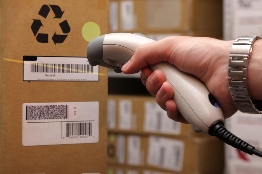 Man hand with barcode scanner in operation