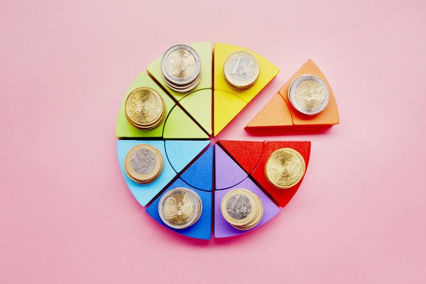 Pie chart made of colorful building blocks and stacks of Euro coins