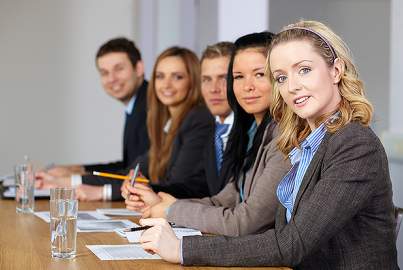 Team of 5 business people with blonde female on foreground