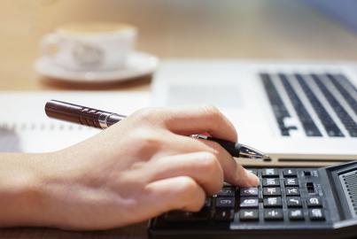 Woman hand working with calculator