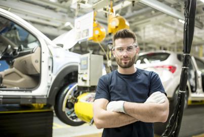 Porträt eines selbstbewussten Arbeiters in einer modernen Autofabrik