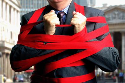 Businessman bound up in red tape